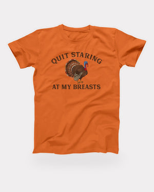 Quit Staring At My Breasts T-Shirt in Orange, flat lay on grey