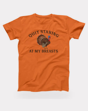 Quit Staring At My Breasts T-Shirt in Orange, flat lay on grey