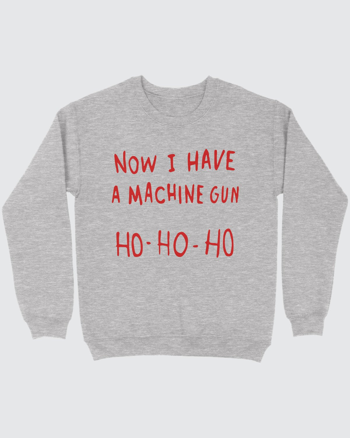Now I Have A Machine Gun Ho Ho Ho ugly sweater in Sport Grey, flat lay on grey