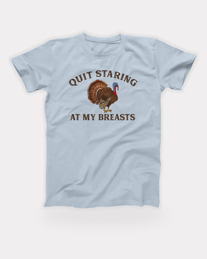 Quit Staring At My Breasts T-Shirt in Light Blue, flat lay on grey